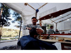 Kırıkhanlı berber müşterilerini kurduğu çadırda tıraş ediyor